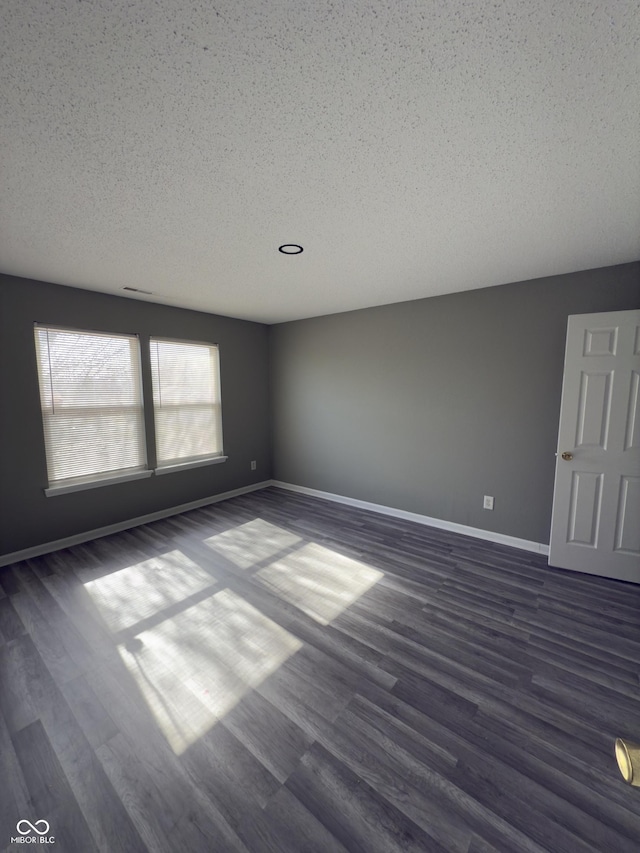 1881 Harvest Meadow Dr, Greenwood, IN 46143 - empty room featuring a textured ceiling and dark wood-style floors