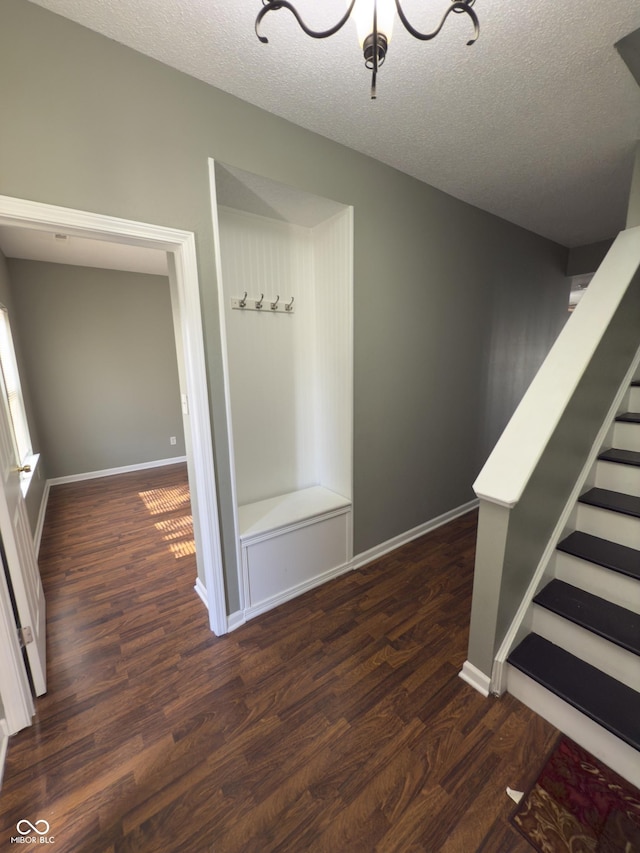 1881 Harvest Meadow Dr, Greenwood, IN 46143 - stairs featuring wood finished floors, a textured ceiling, and a chandelier