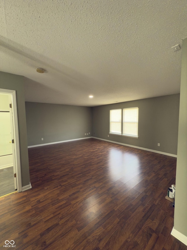1881 Harvest Meadow Dr, Greenwood, IN 46143 - spare room featuring a textured ceiling and dark wood-style floors