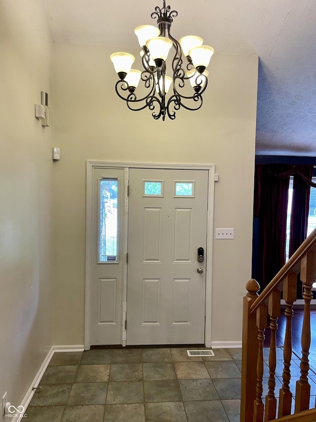 7410 Crickwood Pl, Indianapolis, IN 46268 - foyer entrance featuring a chandelier and baseboards