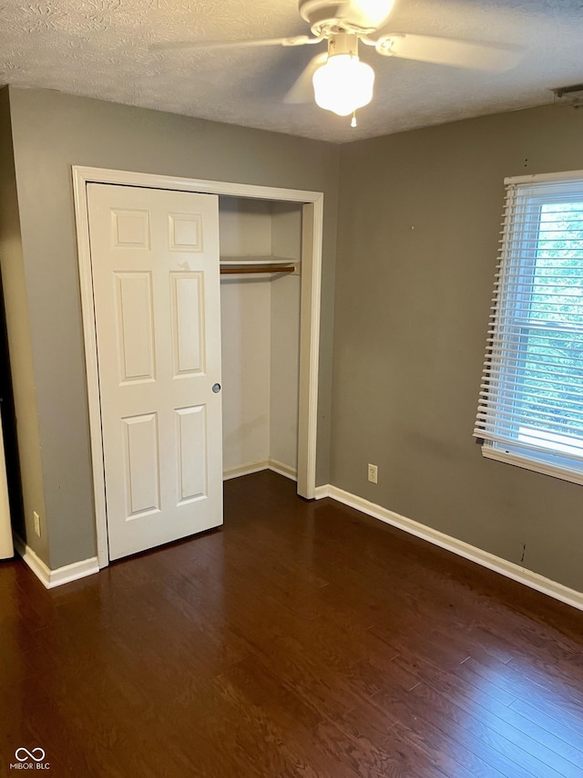7410 Crickwood Pl, Indianapolis, IN 46268 - unfurnished bedroom with dark wood-type flooring, a closet, and ceiling fan