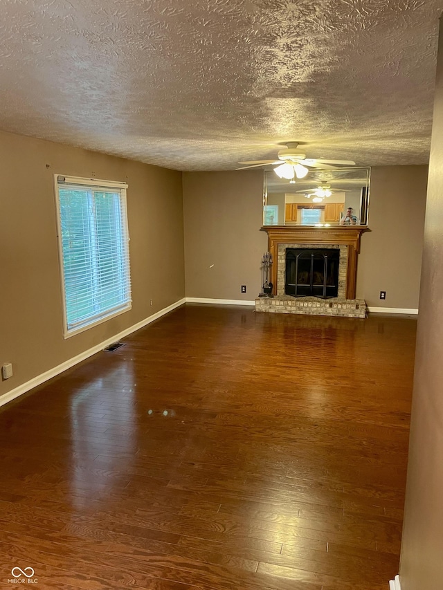 7410 Crickwood Pl, Indianapolis, IN 46268 - unfurnished living room featuring a textured ceiling, ceiling fan, wood finished floors, and a fireplace