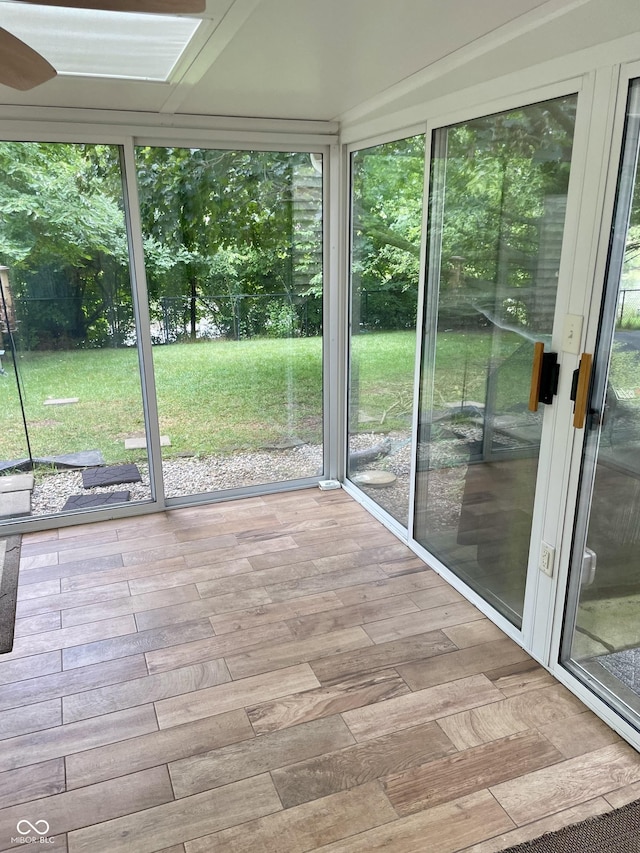 7410 Crickwood Pl, Indianapolis, IN 46268 - unfurnished sunroom with healthy amount of natural light, wood finished floors, and ceiling fan