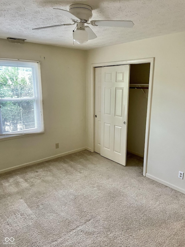 7410 Crickwood Pl, Indianapolis, IN 46268 - unfurnished bedroom with light carpet, a closet, a textured ceiling, and ceiling fan