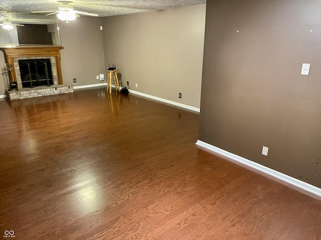 7410 Crickwood Pl, Indianapolis, IN 46268 - unfurnished living room with a ceiling fan, wood finished floors, and a brick fireplace