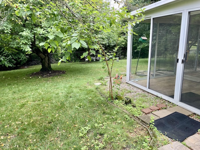 7410 Crickwood Pl, Indianapolis, IN 46268 - view of grassy yard featuring a sunroom