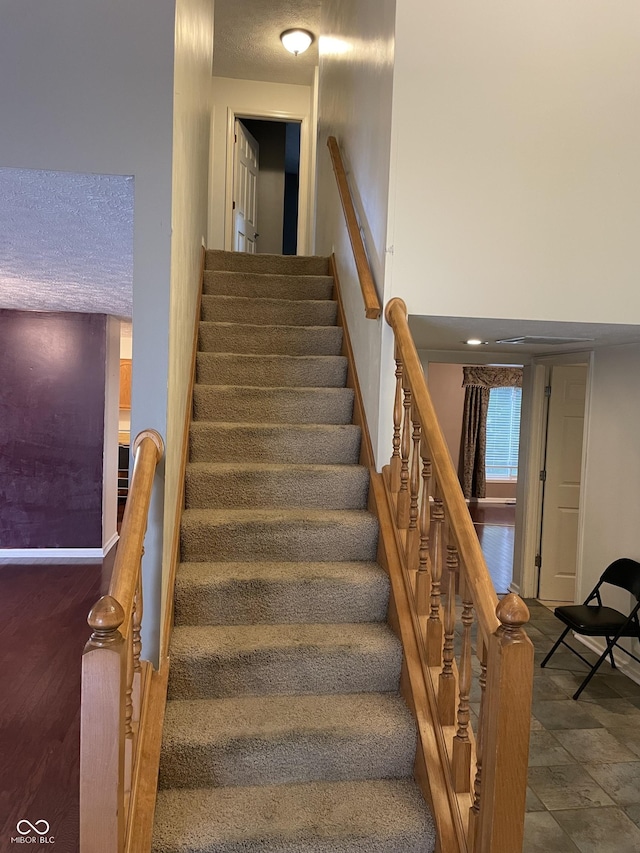 7410 Crickwood Pl, Indianapolis, IN 46268 - staircase featuring a textured ceiling
