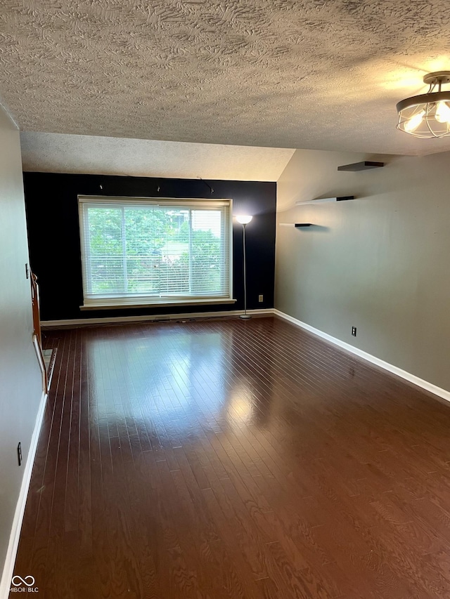 7410 Crickwood Pl, Indianapolis, IN 46268 - unfurnished room featuring a textured ceiling and dark wood finished floors