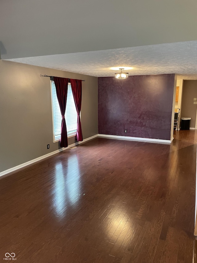 7410 Crickwood Pl, Indianapolis, IN 46268 - spare room featuring dark wood-type flooring and a textured ceiling
