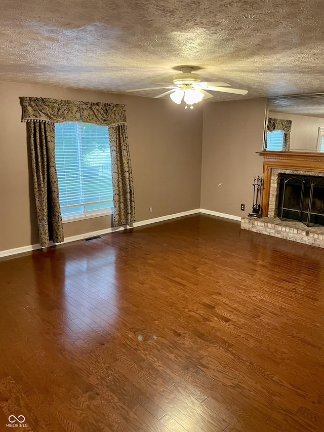 7410 Crickwood Pl, Indianapolis, IN 46268 - unfurnished living room with a textured ceiling, wood finished floors, a ceiling fan, and a brick fireplace