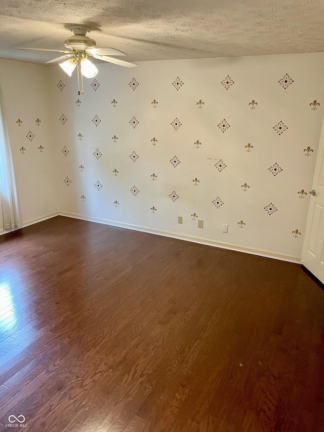 7410 Crickwood Pl, Indianapolis, IN 46268 - unfurnished room with dark wood-type flooring, a textured ceiling, and ceiling fan