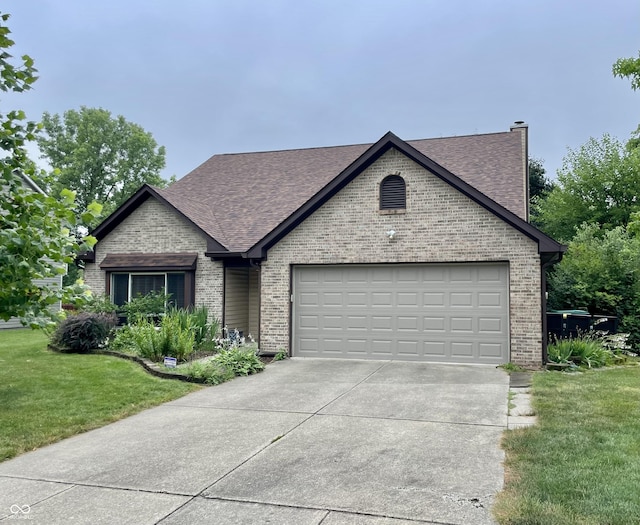 7410 Crickwood Pl, Indianapolis, IN 46268 - view of front of property featuring brick siding, concrete driveway, an attached garage, a front yard, and roof with shingles