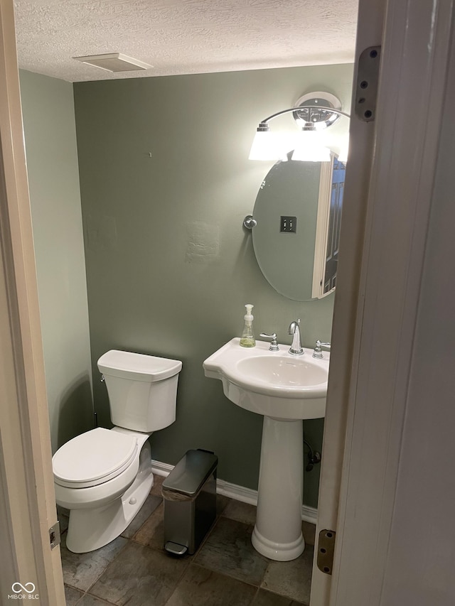 7410 Crickwood Pl, Indianapolis, IN 46268 - half bathroom featuring a textured ceiling and toilet