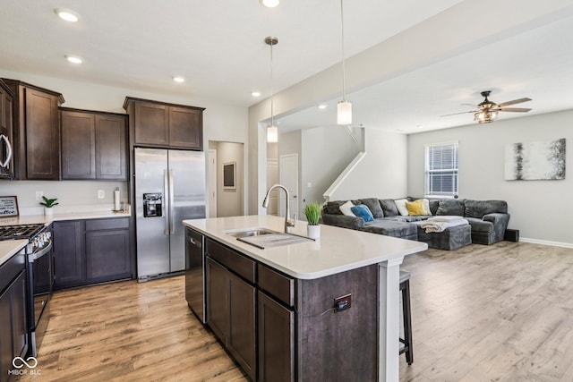 338 Limerick Ln, Pendleton, IN 46064 - kitchen featuring stainless steel appliances, light wood-style flooring, dark brown cabinets, light countertops, and recessed lighting
