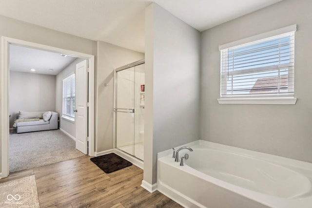 338 Limerick Ln, Pendleton, IN 46064 - full bathroom with a garden tub, a stall shower, and wood finished floors