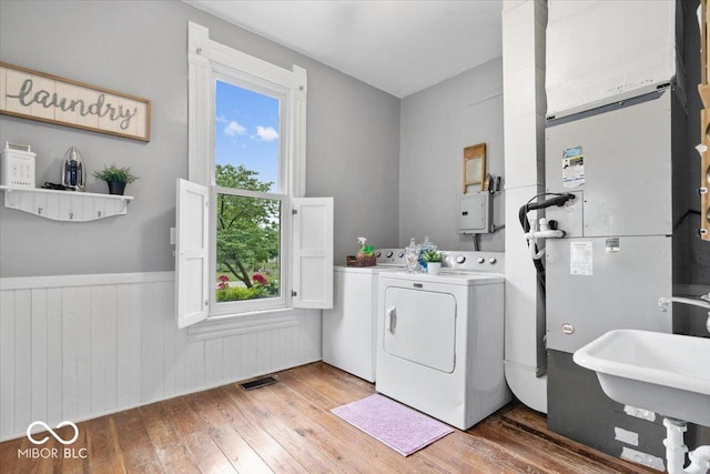 3160 S 50 E, Lebanon, IN 46052 - washroom with washing machine and dryer, light wood-type flooring, and a wainscoted wall