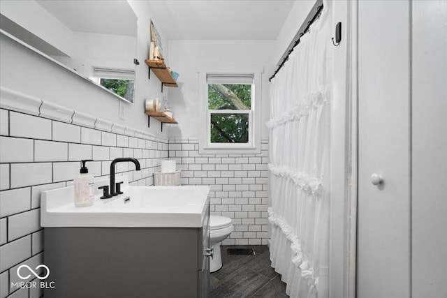 3160 S 50 E, Lebanon, IN 46052 - bathroom featuring vanity, tile walls, plenty of natural light, a wainscoted wall, and curtained shower