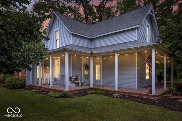3160 S 50 E, Lebanon, IN 46052 - country-style home with covered porch, a shingled roof, a chimney, and a front yard