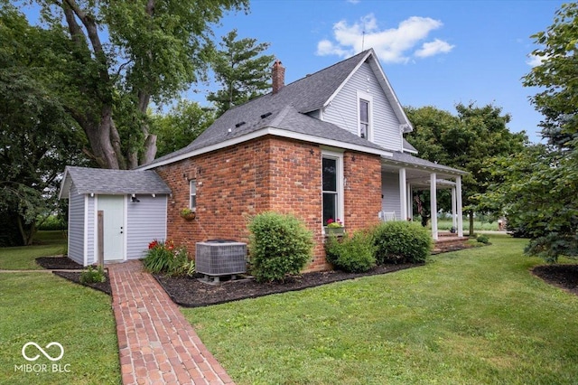 3160 S 50 E, Lebanon, IN 46052 - view of side of home featuring a lawn, a chimney, a shed, roof with shingles, and brick siding