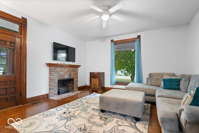 3160 S 50 E, Lebanon, IN 46052 - living area with wood finished floors, healthy amount of natural light, a ceiling fan, and a brick fireplace