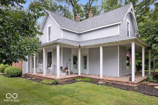 3160 S 50 E, Lebanon, IN 46052 - farmhouse featuring a porch, a chimney, a shingled roof, and a front lawn