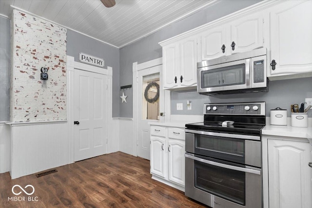 3160 S 50 E, Lebanon, IN 46052 - kitchen with stainless steel appliances, light countertops, wainscoting, white cabinets, and dark wood-style flooring