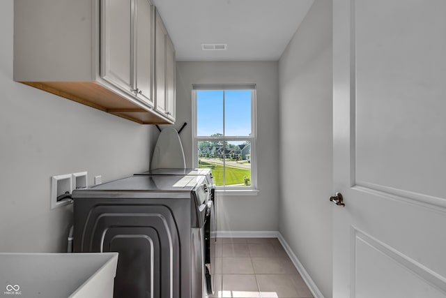 19174 Foley Dr, Westfield, IN 46074 - laundry area with washer and clothes dryer, cabinet space, and light tile patterned floors