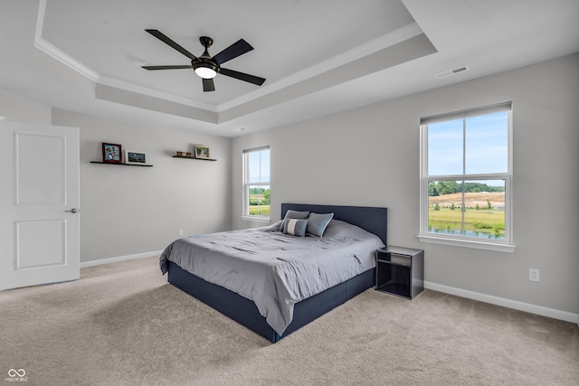19174 Foley Dr, Westfield, IN 46074 - carpeted bedroom with a tray ceiling, ornamental molding, and a ceiling fan