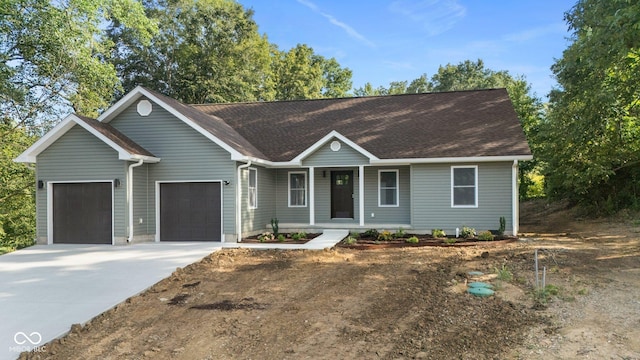 6530 W US Highway 50, North Vernon, IN 47265 - single story home with a garage, covered porch, driveway, and a shingled roof