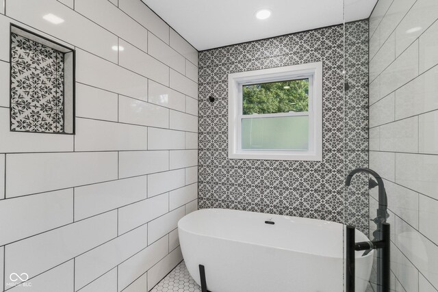 6530 W US Highway 50, North Vernon, IN 47265 - bathroom featuring a freestanding tub and tile walls