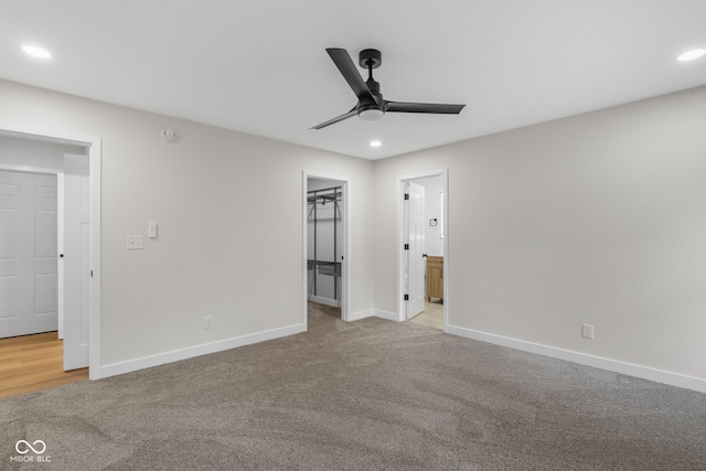 6530 W US Highway 50, North Vernon, IN 47265 - unfurnished bedroom with carpet floors, recessed lighting, a walk in closet, ensuite bath, and a ceiling fan