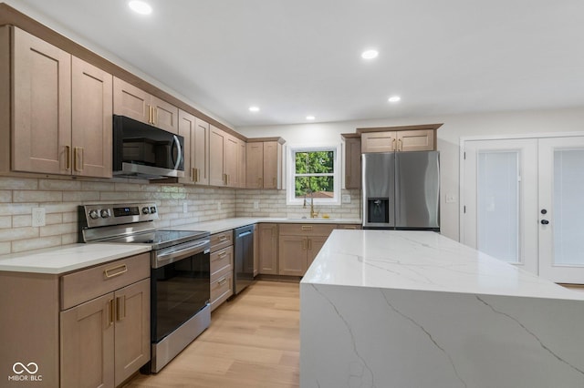 6530 W US Highway 50, North Vernon, IN 47265 - kitchen with appliances with stainless steel finishes, light wood-style flooring, tasteful backsplash, light stone countertops, and recessed lighting
