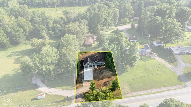 6530 W US Highway 50, North Vernon, IN 47265 - aerial view of property and surrounding area featuring a heavily wooded area and property parcel outlined