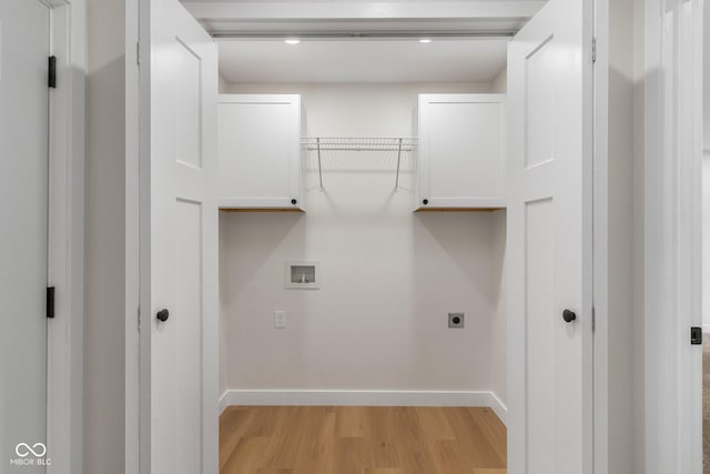 6530 W US Highway 50, North Vernon, IN 47265 - laundry area featuring cabinet space, light wood-style flooring, hookup for an electric dryer, and washer hookup
