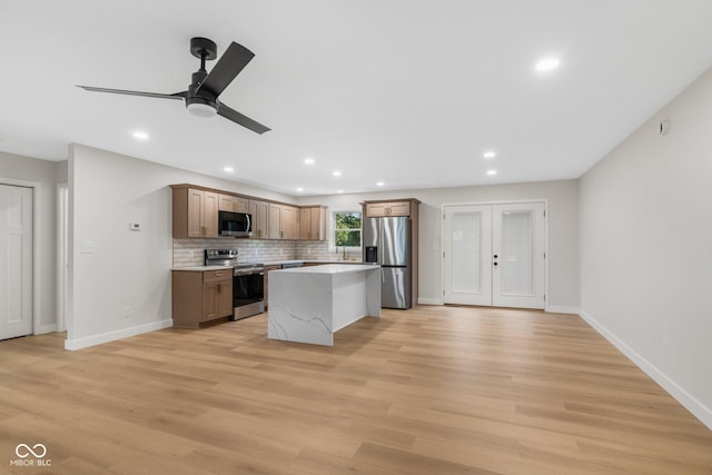 6530 W US Highway 50, North Vernon, IN 47265 - kitchen featuring appliances with stainless steel finishes, a ceiling fan, a kitchen island, recessed lighting, and light wood-type flooring
