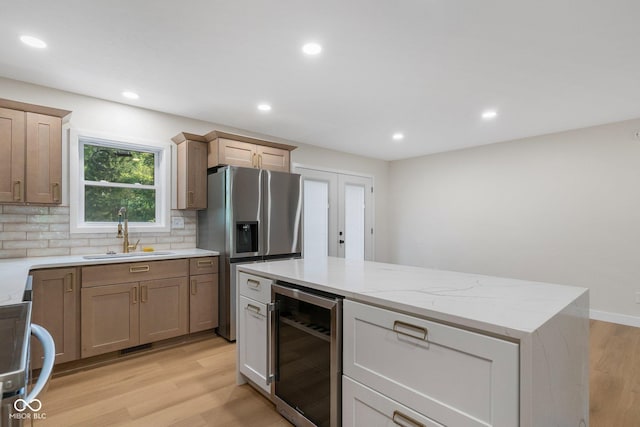 6530 W US Highway 50, North Vernon, IN 47265 - kitchen with beverage cooler, stainless steel fridge, backsplash, light wood finished floors, and range