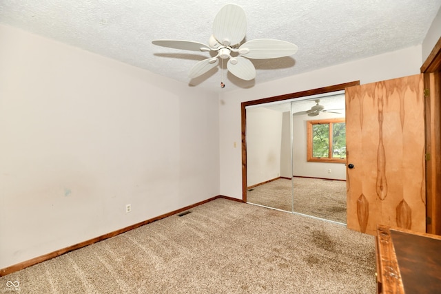5202 Hill Valley Dr, Pittsboro, IN 46167 - unfurnished bedroom featuring light colored carpet, a textured ceiling, a closet, and a ceiling fan