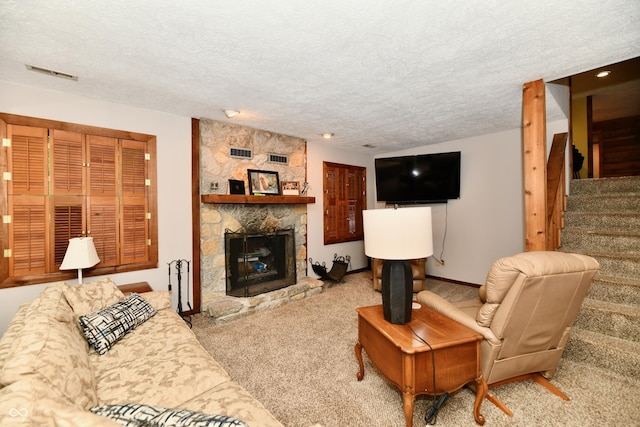 5202 Hill Valley Dr, Pittsboro, IN 46167 - carpeted living area featuring stairs, a textured ceiling, and a fireplace