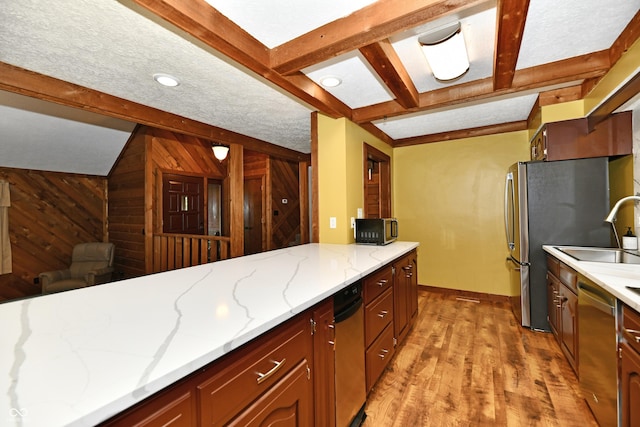5202 Hill Valley Dr, Pittsboro, IN 46167 - kitchen featuring appliances with stainless steel finishes, light wood-type flooring, beam ceiling, wooden walls, and light stone countertops