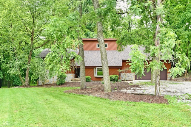 5202 Hill Valley Dr, Pittsboro, IN 46167 - view of front of home featuring stone siding, a front yard, a shingled roof, and driveway