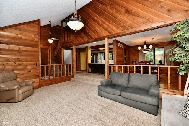 5202 Hill Valley Dr, Pittsboro, IN 46167 - unfurnished living room featuring wood walls, carpet, a chandelier, and vaulted ceiling