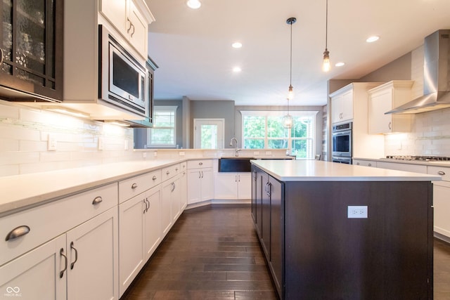 1434 Shootingstar Way, West Lafayette, IN 47906 - kitchen with wall chimney exhaust hood, appliances with stainless steel finishes, light countertops, dark wood finished floors, and recessed lighting