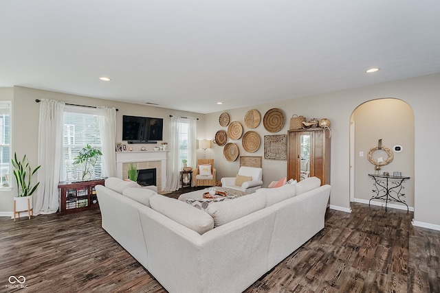 801 Oaklawn Dr, Westfield, IN 46074 - living area featuring a fireplace, dark wood finished floors, arched walkways, and recessed lighting