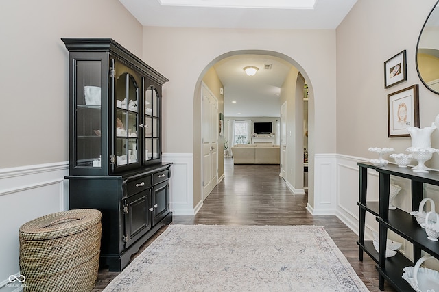 801 Oaklawn Dr, Westfield, IN 46074 - corridor featuring arched walkways, dark wood-style flooring, a wainscoted wall, and a decorative wall