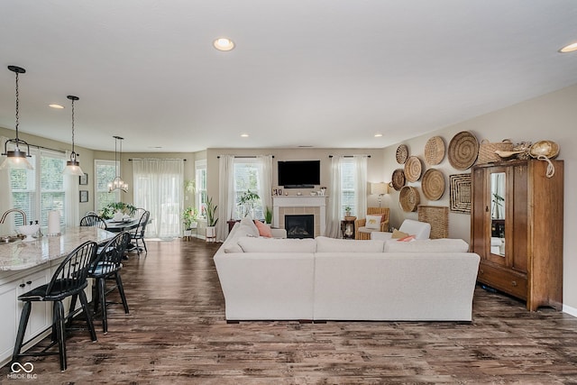 801 Oaklawn Dr, Westfield, IN 46074 - living area with dark wood finished floors, a tiled fireplace, and recessed lighting