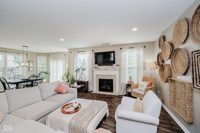 801 Oaklawn Dr, Westfield, IN 46074 - living area with healthy amount of natural light, dark wood-style flooring, a tile fireplace, and recessed lighting