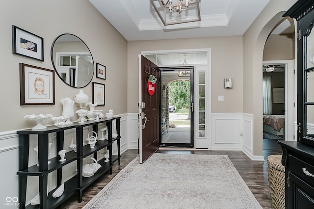 801 Oaklawn Dr, Westfield, IN 46074 - entrance foyer featuring a chandelier, arched walkways, dark wood-style flooring, wainscoting, and a decorative wall