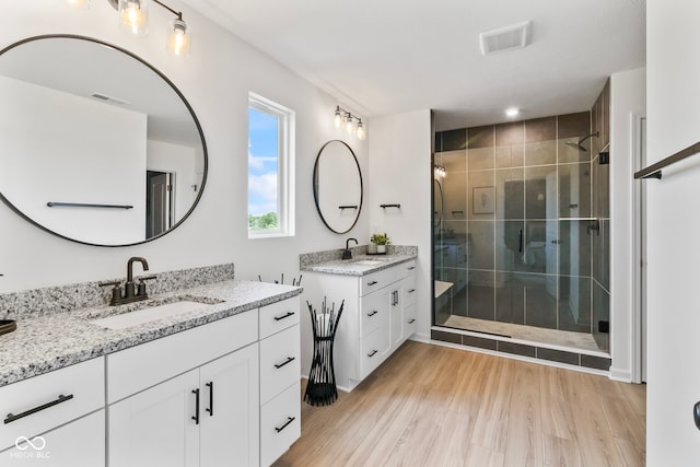 13644 Haven Cove Ln, Fishers, IN 46055 - full bath with a shower stall, two vanities, and wood finished floors
