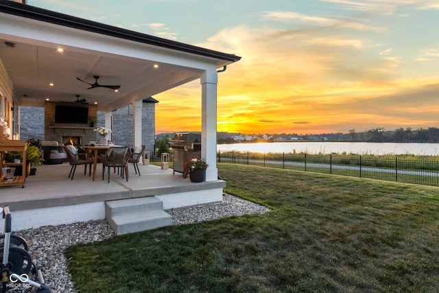 13644 Haven Cove Ln, Fishers, IN 46055 - view of yard with a warm lit fireplace, a patio, and a ceiling fan