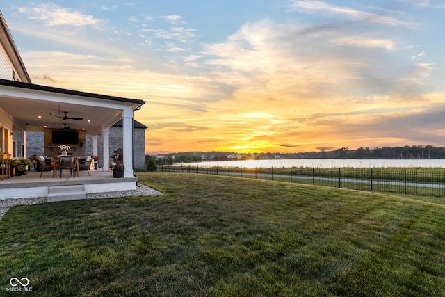 13644 Haven Cove Ln, Fishers, IN 46055 - yard at dusk featuring ceiling fan, a water view, and a patio